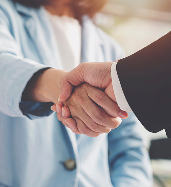 A buyer and supplier shaking hands